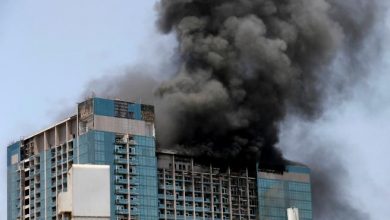 Smoke rises after a fire broke out in a building at Al Maryah Island in Abu Dhabi