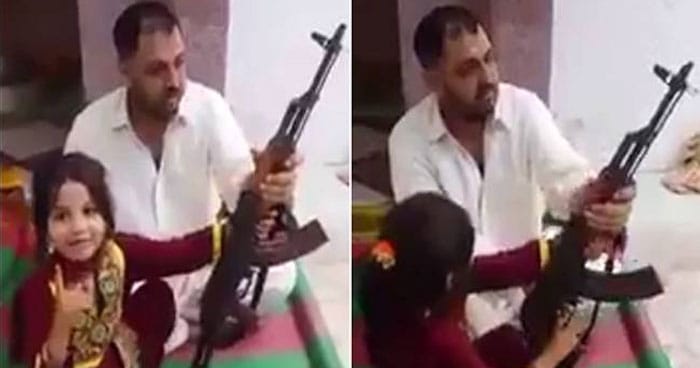 Pakistani father makes little girl fire AK-47