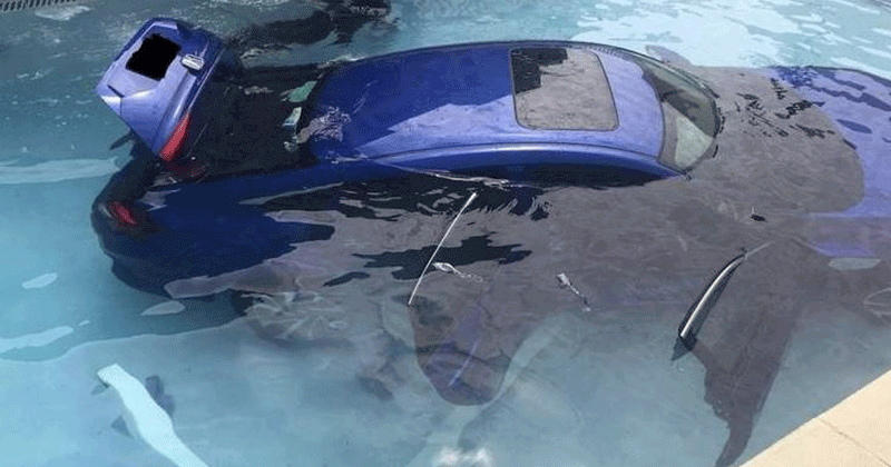 Car rolls back into swimming pool