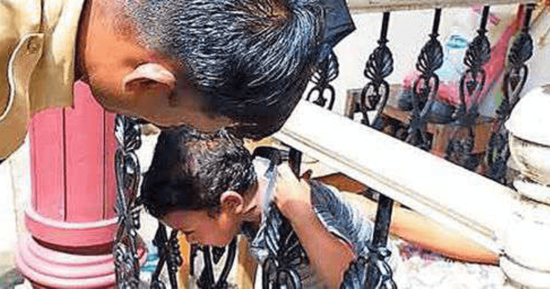 BOY'S HEAD STUCK BETWEEN BARS